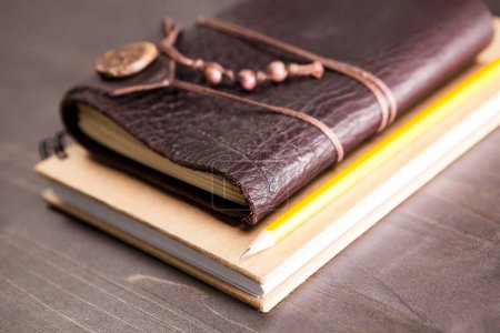 Photo for Vintage diary with leather cover on wooden backgorund - Royalty Free Image