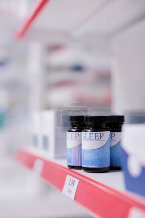 Téléchargez les photos : Health care store shelves filled with medicaments and pharmaceutical products to sell prescription medicine or treatment to clients. Empty pharmacy with medication, supplements and vitamins, pills - en image libre de droit