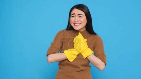 Photo for Happy professional maid being happy about finishing home cleaning while enjoying appreciation from her clients. Homekepper doing wonderful job, making sure every inch of the house was spotless. - Royalty Free Image