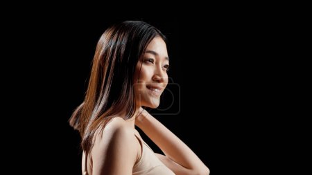Photo for Female model with natural bare skin posing for beauty ad, promoting gentle uplifting products in studio. Woman expressing self love and beauty of imperfections, radiant glowing look. - Royalty Free Image