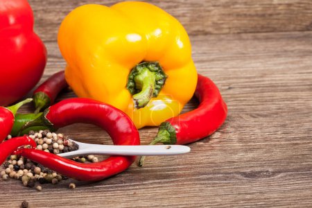 Photo for Spicy and sweet pepper on wooden background in studio photo. Healthy eating - Royalty Free Image