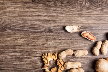 Photo for Raw organic food and nuts on wooden background. Over top view - Royalty Free Image