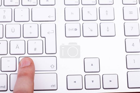 Foto de Pulsando el dedo en la tecla del teclado en primer plano - Imagen libre de derechos
