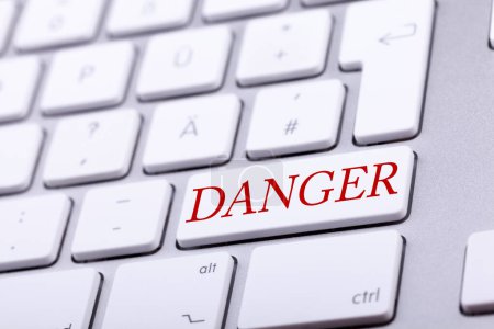 Photo for High end aluminium keyboard with DANGER word in red on it. Danger and alert - Royalty Free Image