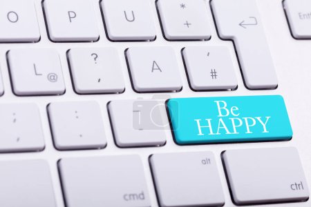 Photo for Elegant keyboard with BE HAPPY word in blue button close up photo - Royalty Free Image