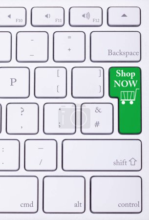 Photo for Shop now green key on aluminium keyboard. Sale and online shoping. Consumerism - Royalty Free Image