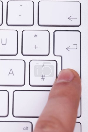 Foto de Dedo presionando la tecla enter en el teclado. Surf en línea - Imagen libre de derechos
