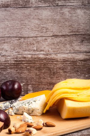 Téléchargez les photos : Apéritif gastronomique au fromage sur fond de bois. Collation épicerie fine - en image libre de droit