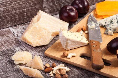Téléchargez les photos : Une nourriture saine. Fruits, noix et fromage sur fond de bois - en image libre de droit