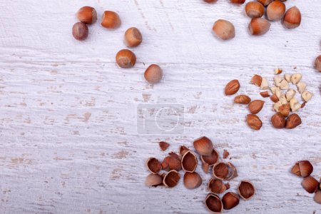 Photo for Hazelnuts on wooden background. Over top view - Royalty Free Image
