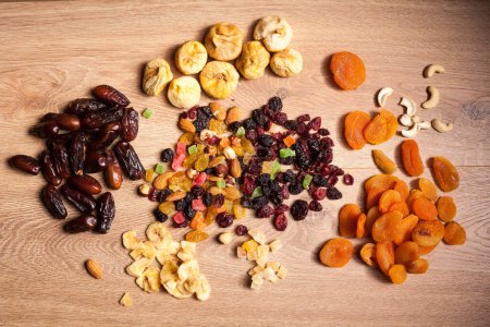 Photo for Mix of dried nuts and fruits on wooden background - Royalty Free Image
