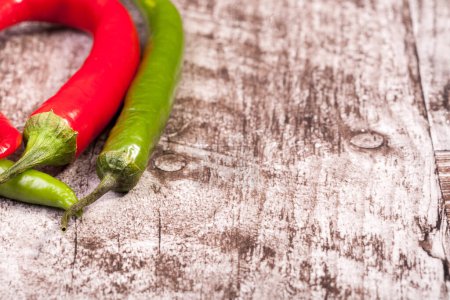 Photo for Spicy Red and green pepper on wooden background in studio photo - Royalty Free Image