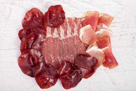 Photo for Delicoius italian ham on wooden background. Over top view - Royalty Free Image