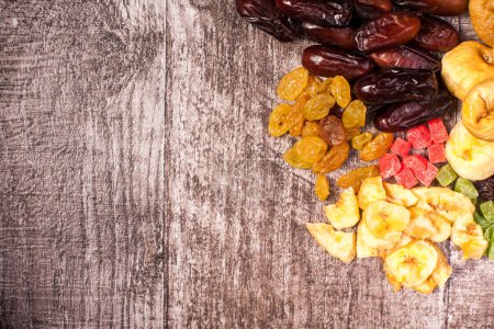Photo for Dried fruits on wooden background in close up photo - Royalty Free Image