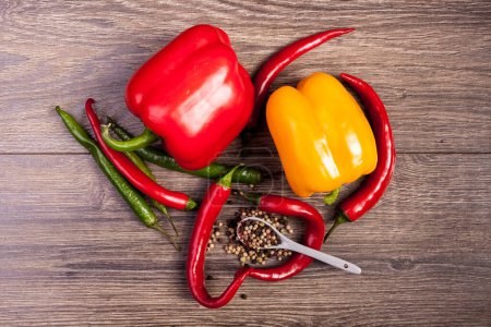 Photo for Spicy and sweet pepper on wooden background. Healthy food - Royalty Free Image