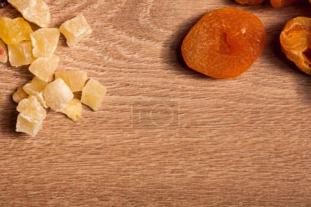Photo for Dried fruits and nuts on wooden background in studio setup. Raw healthy lifestyle - Royalty Free Image