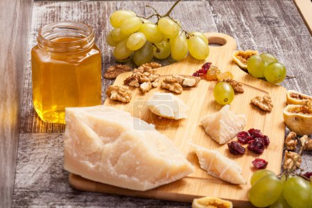 Photo for Cheese, honey and grape on wooden background in studio photo - Royalty Free Image