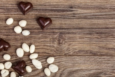 Photo for Heart shaped chocolate on vintage wooden background in studio photo - Royalty Free Image