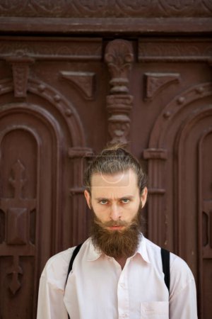 Photo for Hipster with long beard looking at the camera. Style and diversity - Royalty Free Image