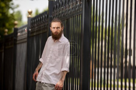 Photo for Fashion cool bearded hipster posing outside in the city. Style and diversity - Royalty Free Image