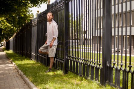 Photo for Bearded hipster posing outside in the city. Style and diversity - Royalty Free Image