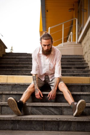 Photo for Tattoed and bearded hipster guy posing outdoor in the city - Royalty Free Image