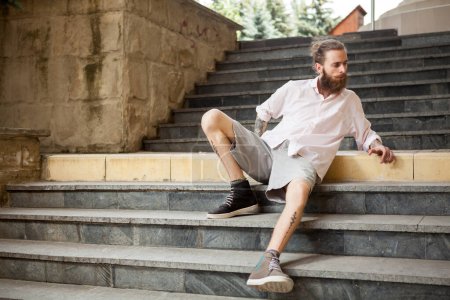 Photo for Fashion tattoed and bearded guy posing outdoor in the city - Royalty Free Image