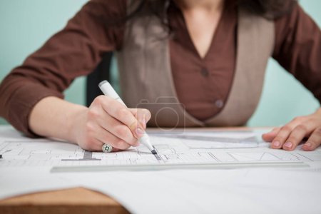 Photo for Architect woman at her table drawing on blueprints. Business and creativity. Architecture job - Royalty Free Image