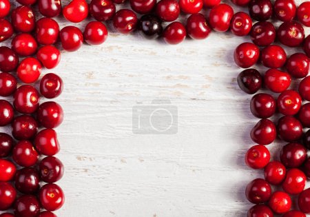 Photo for Fresh cherries on wooden table with centered copyspace available - Royalty Free Image