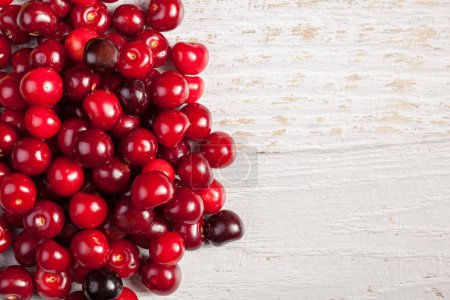 Photo for Juicy fresh cherry on wooden background. Vitamin, summer and healthy lifestyle - Royalty Free Image