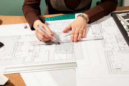 Photo for Close up of architect hands working on blueprints. Design and pan. Professional drawing of architect plans - Royalty Free Image