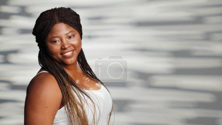 Photo for Glowing model promoting confidence in empowering ad, advertising skincare campaign on camera. Natural adult with radiant skin feeling flawless and glamour in studio, self care. - Royalty Free Image