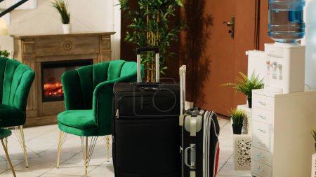 Photo for Luggage trolley bags in hotel lobby next to lounge area couch, baggage and modern furniture at resort reception. Classy elegant decorations at front desk, booking registration. - Royalty Free Image