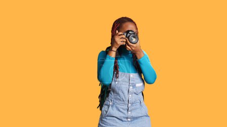 Photo for Female traveller using camera for photos, taking pictures with dslr equipment on urban adventure. Young photographer sightseeing and using lens to make memories, citybreak abroad. - Royalty Free Image