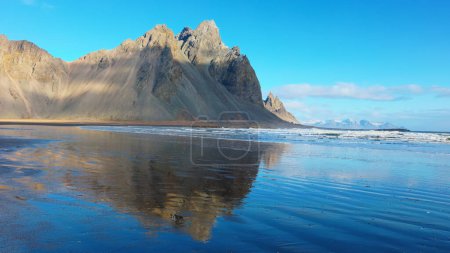Photo for Massive mountain range meeting the ocean, beautiful icelandic landscapes with black sand beach. Arctic stokksnes peninsula with vestrahorn mountains and ocean coastline, sightseeing. - Royalty Free Image