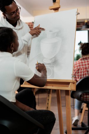 Photo for Young happy African American couple spending time together at art class, learning to draw, trying new things to strengthen relationships, family wife and husband enjoying artistic hobby together - Royalty Free Image