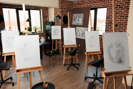 Photo for Creative leisure activities and group art classes, drawing academy interior. Empty art school interior with wooden easels standing in row, no people. Pencil sketching lessons, visual arts education - Royalty Free Image
