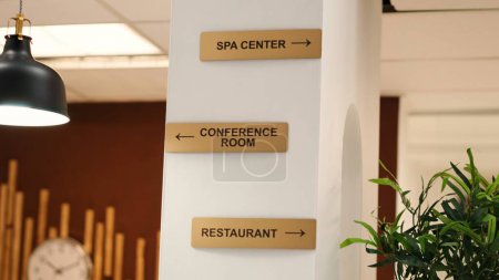 Photo for Empty stylish business accommodationlobby interior with luxurious deluxe conference room, spa center and restaurant amenities. Close up of hotel facilities plaque signs on resort lounge wall - Royalty Free Image