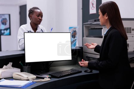 Photo for Reception worker manages patient records and schedules appointments typing medical information on computer with white isolated screen. Hospital staff working at health care treatment for patients - Royalty Free Image
