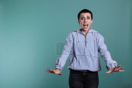 Photo for Afraid terrified woman having scared expression after hearing the bad news, nervous person standing in studio posing over isolated background. Frightened female looking at camera with shock reaction - Royalty Free Image