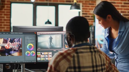 Photo for Professional video editors analyzing film montage before editing color grading and lighting, doing teamwork in creative office. Post production house employees working with video footage. - Royalty Free Image