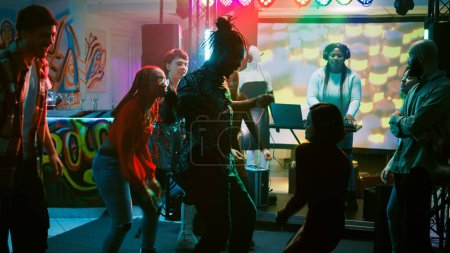Photo for Funky people starting dance battle at party, preparing to show off cool moves on dance floor with friends. Persons having fun with breakdance battle jumping around at discotheque. Handheld shot. - Royalty Free Image