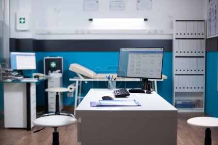Photo for Empty healthcare medical interior, nobody inside modern clinic interior. Computer on desk with clinical examining diagnostic data, checking for disease in doctor medical space - Royalty Free Image