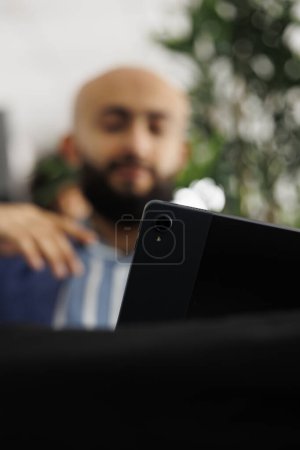 Photo for Blurred manager having video conference call using digital tablet, telecommuting with remote workers in office. Business company project manager teleworking with employees - Royalty Free Image
