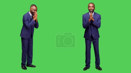 Photo for African american guy doing prayer hands symbol and asking for forgiveness on camera, spiritual gesture. Male entrepreneur praying to god for good fortune, optimistic employee with belief. - Royalty Free Image