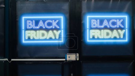 Photo for Front door of department store open on black friday seasonal sales day, cheap merchandise and clothes on special offers. Labels and banners showing deals and discounts in retail shop. - Royalty Free Image