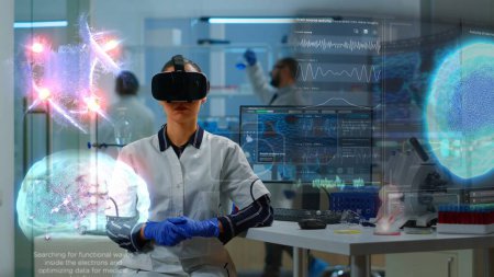 Photo for Scientific specialist in research lab wearing VR goggles using high tech equipment and wired sensors to do medical study. Healthcare practitioner using virtual reality technology to visualize datasets - Royalty Free Image