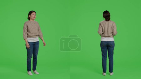 Photo for Furious negative adult standing on full body greenscreen, showing disappointment and disapproval over green screen backdrop. Frustrated upset model being angry and displeased in studio. - Royalty Free Image