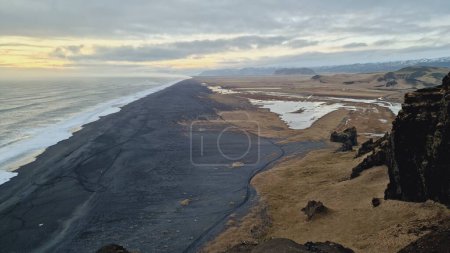 Photo for Drone shot of nordic black sand beach in iceland, majestic ocean coastline and beachfront in wintry weather, creating magical icelandic setting. Majestic atlantic shore with huge waves crashing. - Royalty Free Image
