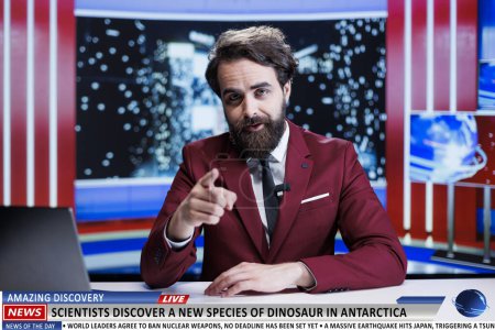 Photo for News anchor talks about rare discovery on live television program, scientists discovered a new dinosaurus species in antarctica. Journalist discussing about bizarre revelation. - Royalty Free Image